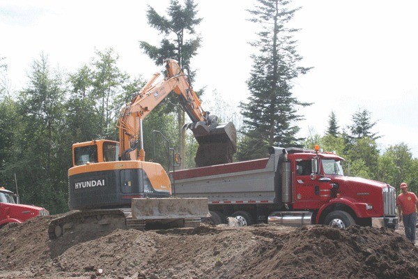 Work crews remove dirt from a site at the end of Gun Club Road. Veterans Northwest Construction is building a 4 million gallon water tank.