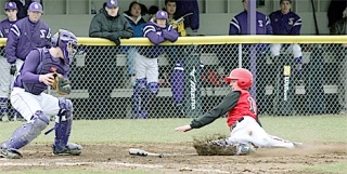 Catcher Brad Farnum has the ball in his glove and the plate blocked