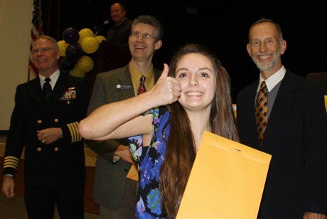 Kelsey Johnson gives a thumbs up to her family after she was honored for an Academic Letter. The ceremony was held in the Student Union Building at Oak Harbor High School.