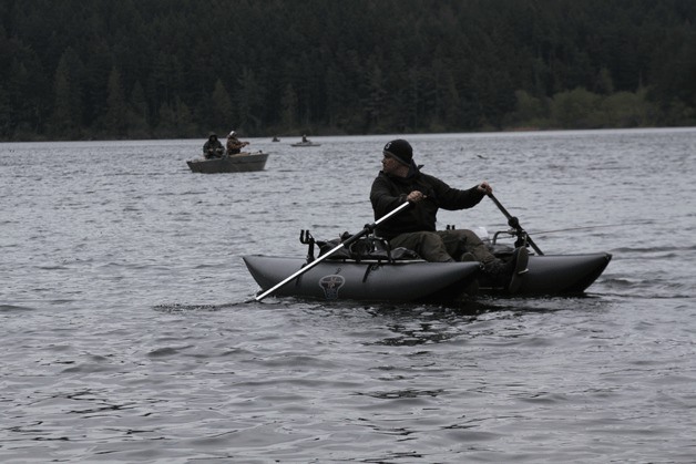 An angler heads to deeper water on Pass Lake in Deception Pass State Park April 19. Only fly fishing is allowed in the lake and no trout may be retained.