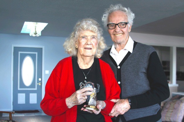 Martha Martin holds a perfume bottle that her husband Bill gave as his first gift to her during Christmas of 1939. The bottle was in the shape of a bride. The Martins live in Langley.