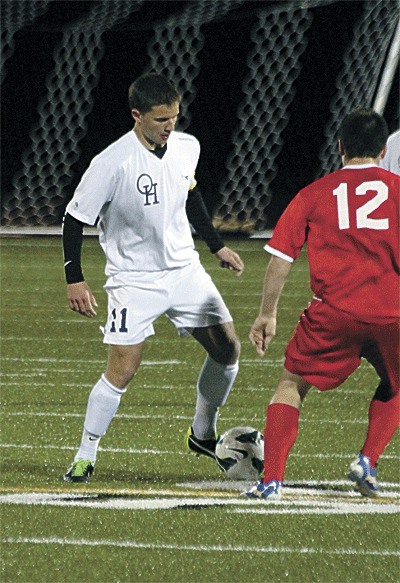 Oak Harbor's Alexander Krantz (11) moves the the ball past Stanwood's Chase Lauinger.