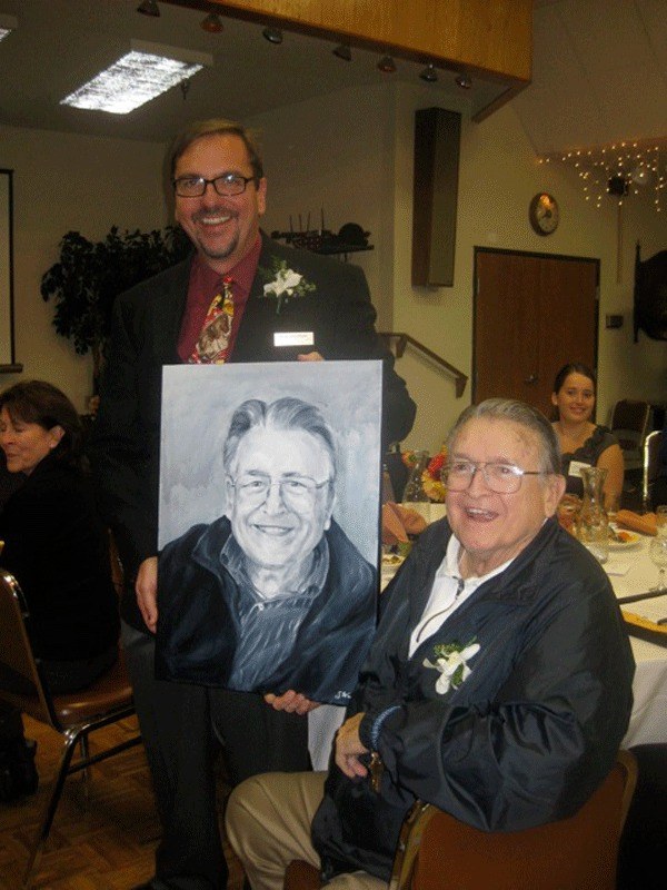 Wallie Funk is presented his portrait by Island County Historical Society Executive Director Rick Castellano. The portrait will be hung at the Island County Museum in Coupeville.