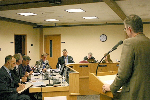 School Board member Peter Hunt asks Assistant Superintendent Lance Gibbon about state testing at the School Board meeting Monday.