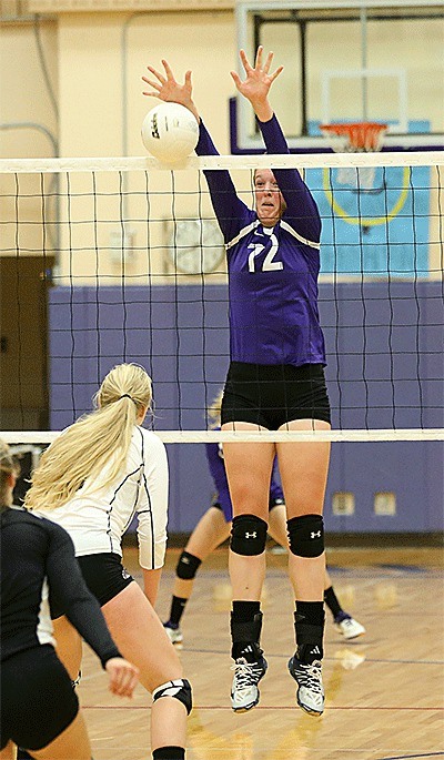 Hailee Blau blocks a Cedarcrest hit in Wednesday's win. She also recorded 23 kills in the match.