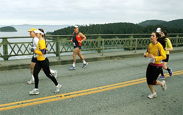 Runners last year cross the Deception Pass bridge near the start of the Whidbey Island Marathon. The bridge will be closed from 7:15 a.m.-7:45 a.m. Sunday.