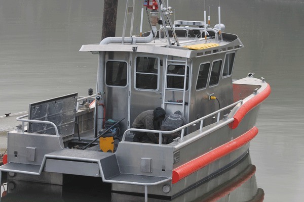 Jake Leonard and Tim Leonard work on the 32-foot catamaran