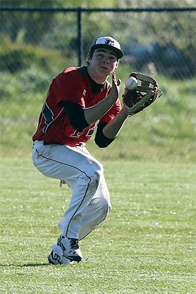 Center fielder Josh Bayne runs down a flyball for the Wolves Thursday.