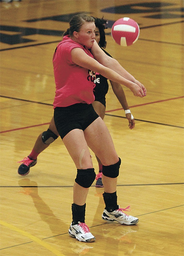 Roshel Muzzall passes for Oak Harbor in thet Wildcats' match with Meadowdale Thursday. Muzzall finished with 20 digs in the match. Oak Harbor wore pink uniforms for Breast Cancer Awareness Week.