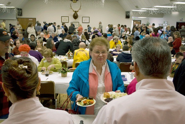 Diners enjoy last year’s free Thanksgiving dinner in Oak Harbor.