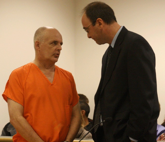 Dr. Donald 'Russell' Johnson speaks to attorney Peter Simpson during a hearing in Island County Superior Court Monday.