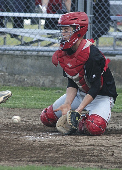 Jake Tumblin blocks a pitch in the dirt for Coupeville. Tumblin said that the summer season helped Coupeville get its confidence back.