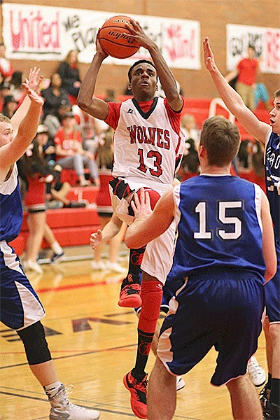 Dante Mitchell draws a crowd of Chimacum defenders on the way to the hoop.