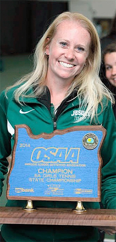 Kirsten Ruchaber holds one of her nine state title trophies.