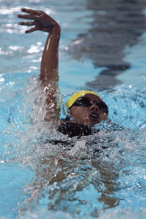 Karina Concepcion swims to first in the 100-meter backstroke Monday. Earlier in the meet she won the 50 freestyle.