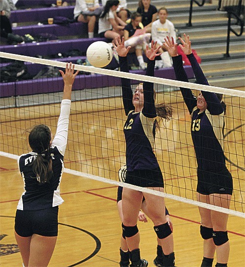 Claire Anderson (12) and Roshel Muzzall (13) join forces to block an Everett attack Thursday.