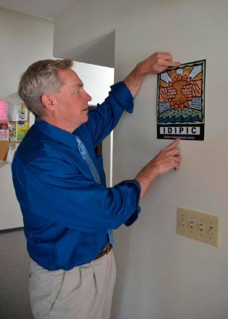 Island County Coroner Robert Bishop hangs up a plaque from IDIPIC.