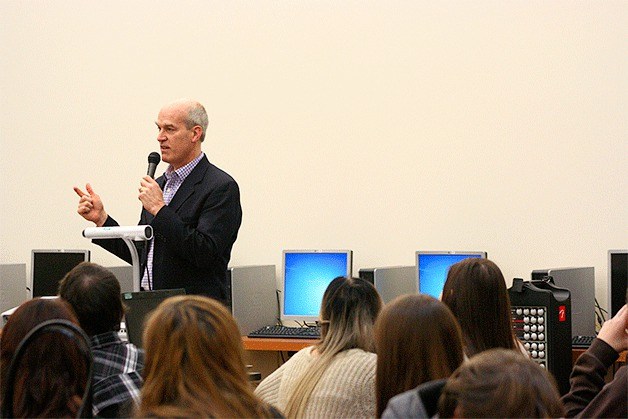 Congressman Rick Larsen answers questions from a room of civics class students in the Oak Harbor High School library Friday as part of a Whidbey Island visit.