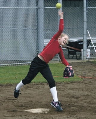 Kaitlyn Curtis makes a strong throw to first base.