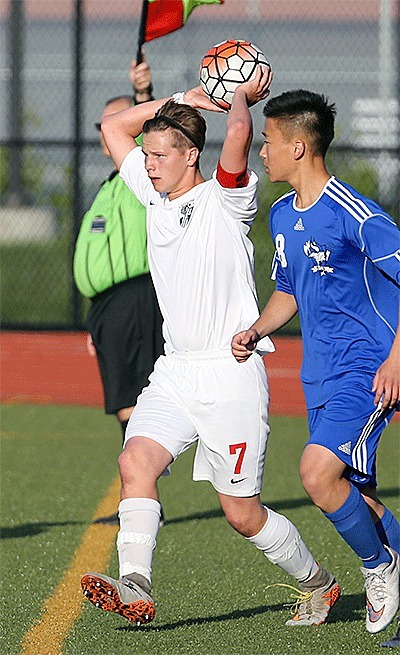 Coupeville's Zane Bundy (7) throws the ball in as BC's Justin Kim looks on. Bundy scored the Wolves' goal in the 2-1 loss.