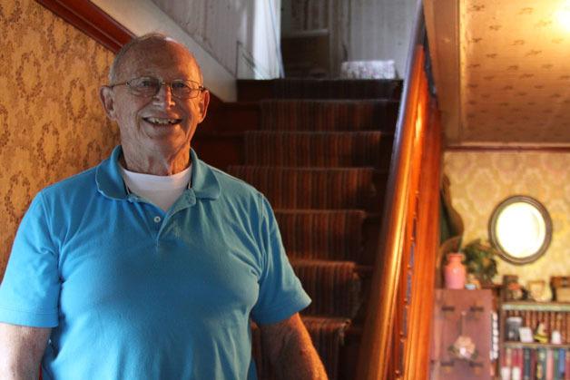 Dave Engle stands in the staircase of the 1858 home in Coupeville where his great grandparents Flora Augusta Pearson Engle and William B. Engle once lived. Dave Engle and his wife Dolores also lived there until a fire in 2006. The Island County Museum this week is releasing a video about the life of Flora Engle.