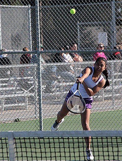 Elma Marie Empinado lets a serve fly in Tuesday's match with Stanwood. Empinado teamed with Ria Bains to win second doubles 6-1