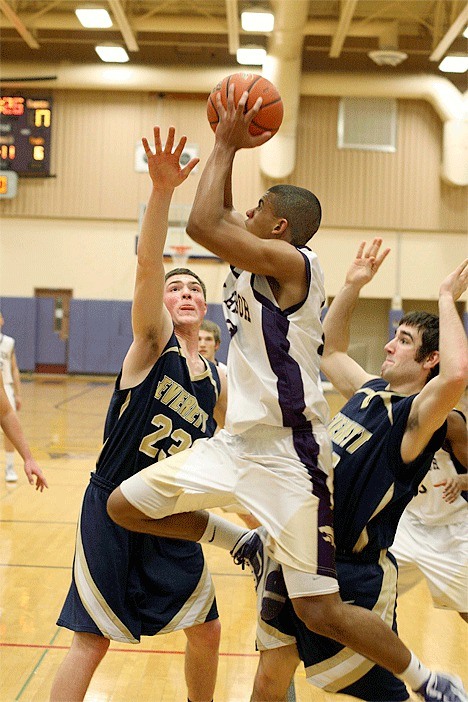 Mike Washington Jr. flies to the hoop in Oak Harbor’s overtime win Tuesday.