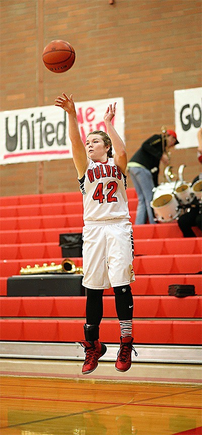 Kailey Kellner lofts a three-pointer in the Wolves' win over Orcas Island. Kellner hit six three-balls and scored 20 points.