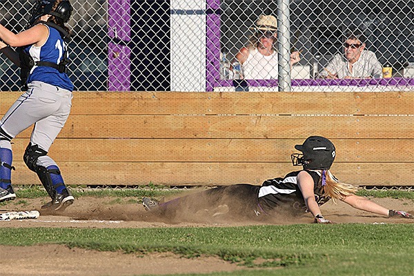 North Whidbey's Kayla Carr slides into home to complete an inside-the-park home run Monday.