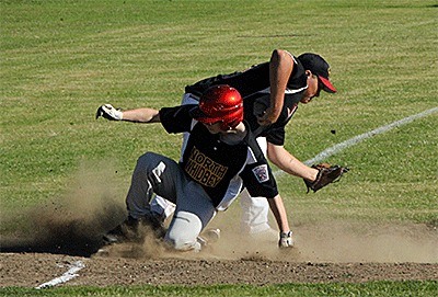 Ashton Mendiola slides safely into third base ahead of the tag by South Skagit's Ty Dill.