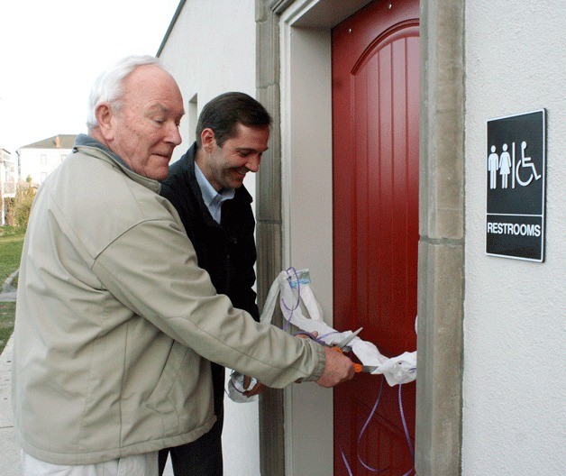 Coupeville Town Council members Bob Clay and Tom Tack cut the ribbon of the new public restrooms located in the new Central Whidbey Chamber of Commerce building.