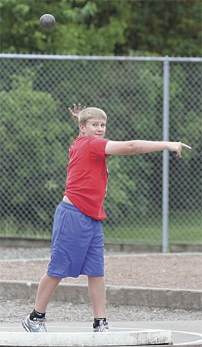 Michael Fisken tosses the shot in Running Unlimited Fitness's first meet. Fisken earned Athlete of the Meet honors by placing in the top three in three events.