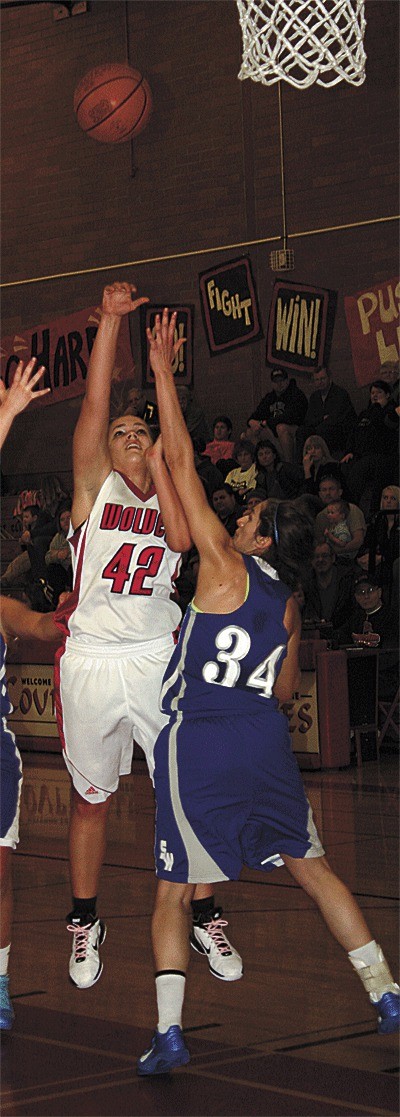 Bessie Walstad shoots over the block of South Whidbey's Lacy Williams.