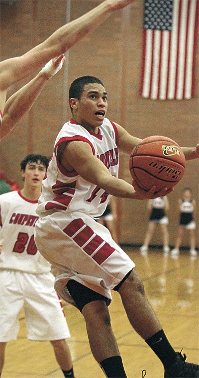 Coupeville's Mitch Pelroy spins to the hoop as Taylor Ebersole looks on.