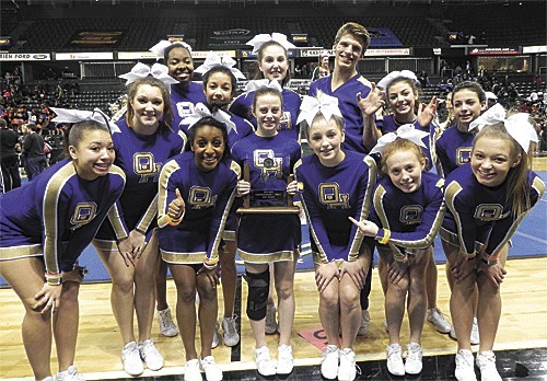 The Oak Harbor cheer squad proudly displays its second-place trophy from the state finals. Bottom left: Chylah Bass