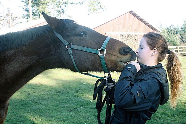 Taryn McKay gives a kiss to Thunder