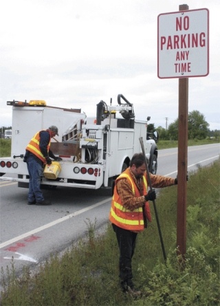 Island County sign supervisor Jeff Barkhausen and sign tech Mike Allen place a sign on Patmore Road Tuesday morning.