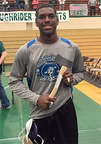 Dymond Piper displays his 'trophy' for winning the Most Valuable Wrestler Award at the Battle of the AXE Tournament in Port Angeles Saturday.