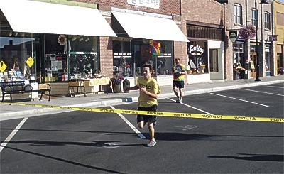 Jeron Kosbar crosses the finish line to win the Pioneer Days 5K.