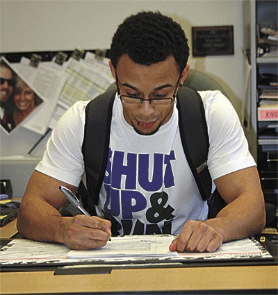 Oak Harbor's Josiah Miller signs a letter of intent to play football at Central Washington.