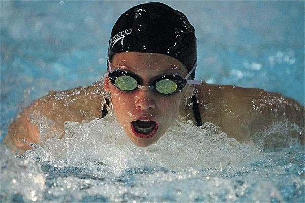 Oak Harbor's Olivia Meyer swims to third place in the 100-meter butterfly in the Wildcats' win Monday. Meyer later placed first in the 100 breaststroke.