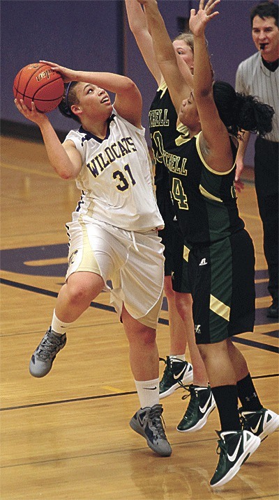 Oak Harbor's Dominique Jackson fights through the defense of Marysville Getchell's Rachael Lefstad (center) and Brianna Lloyd-Bennett.