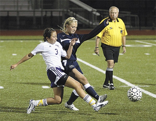 Oak Harbor's McKenzie Schneider tangles with a Glacier Peak in Tuesday's match. Schneider scored in Oak Harbor's 1-1 tie with Lynnwood on Thursday.