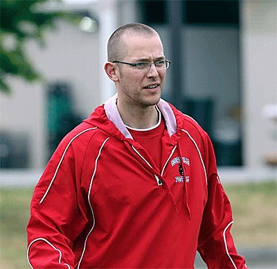 First-year coach Brett Smedley leads the Wolves in a summer workout.