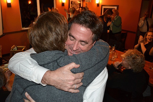 Joe Mosolino and Trish Rose share a celebratory hug Tuesday night after preliminary results show the Whidbey General Hospital bond passing.