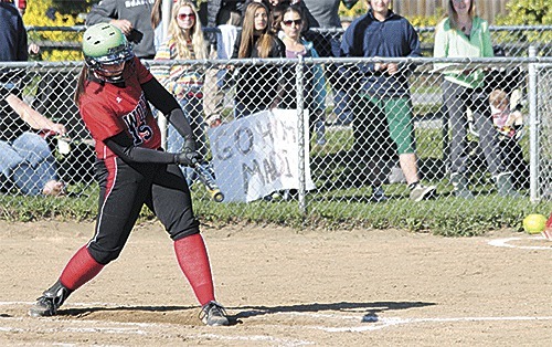 Coupeville's Hailey Hammer rips a single up the middle to drive in a run for the Wolves Monday.