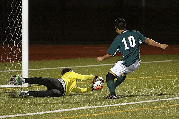 Jared Hoyt makes a save as Shorecrest's Richardo Ruiz closes in.