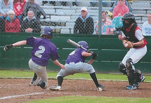 Christian Bertram (2) catches hitter Noah Zuniga and the Olympic catcher off guard by stealing home for Oak Harbor.