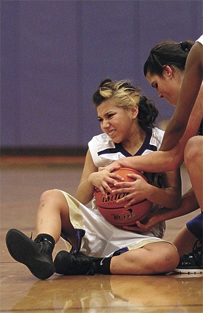 Oak Harbor's Natalie Fiallos fights for a loose ball against Pullman.