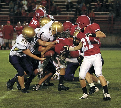 Oak Harbor's Michael Labelle (30) rips the ball from a Stanwood runner